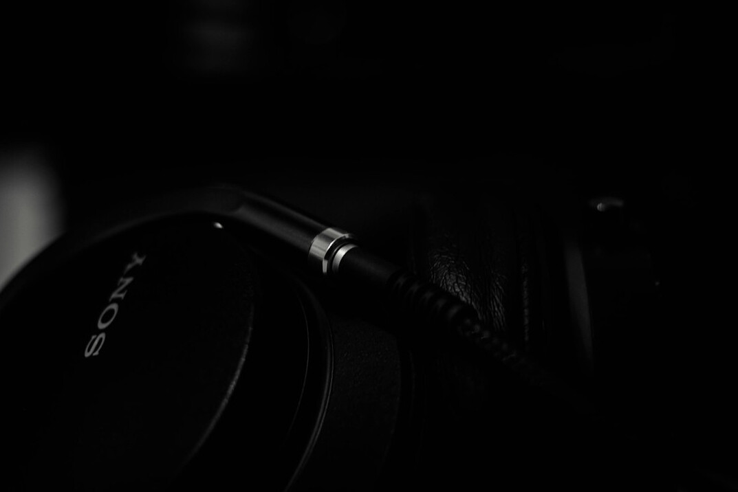 Boom microphone and headphones on a studio desk