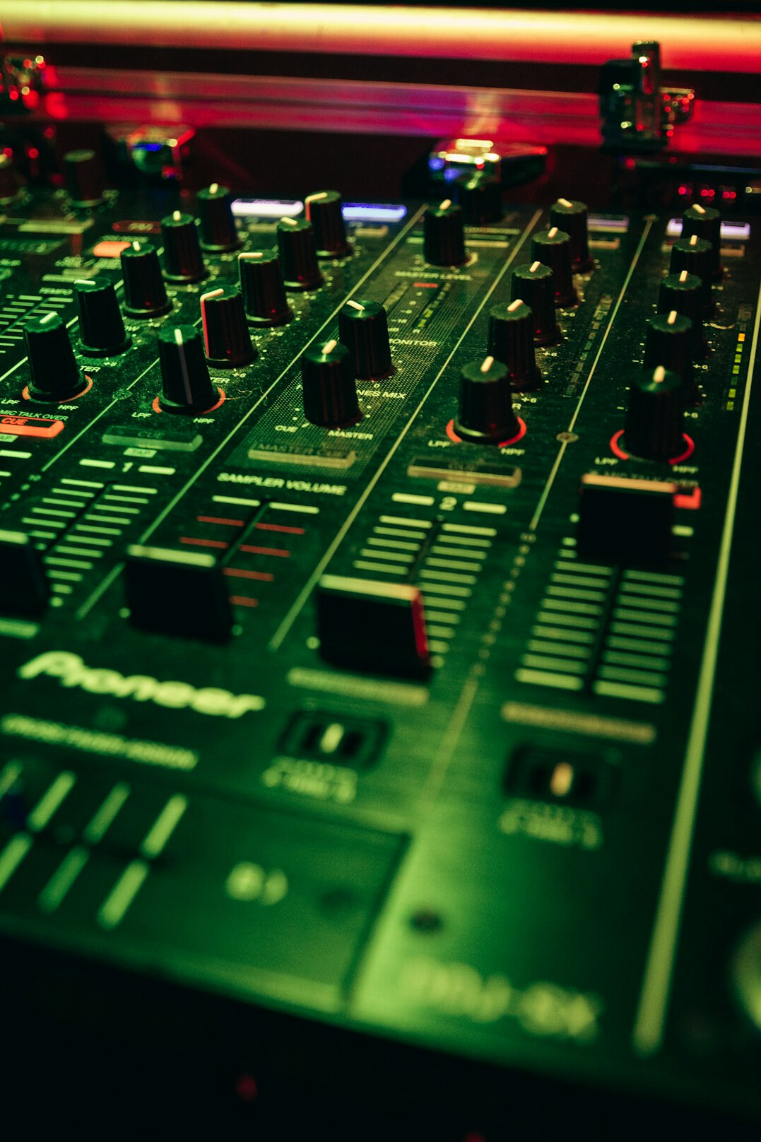 Audio mixing console with faders and knobs